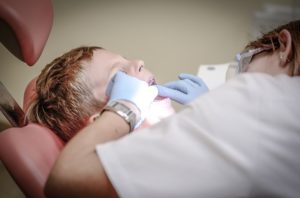 A child getting his teeth cleaned.