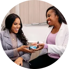 Photo-3-up-female-doctor-handing-female-patient-aligners